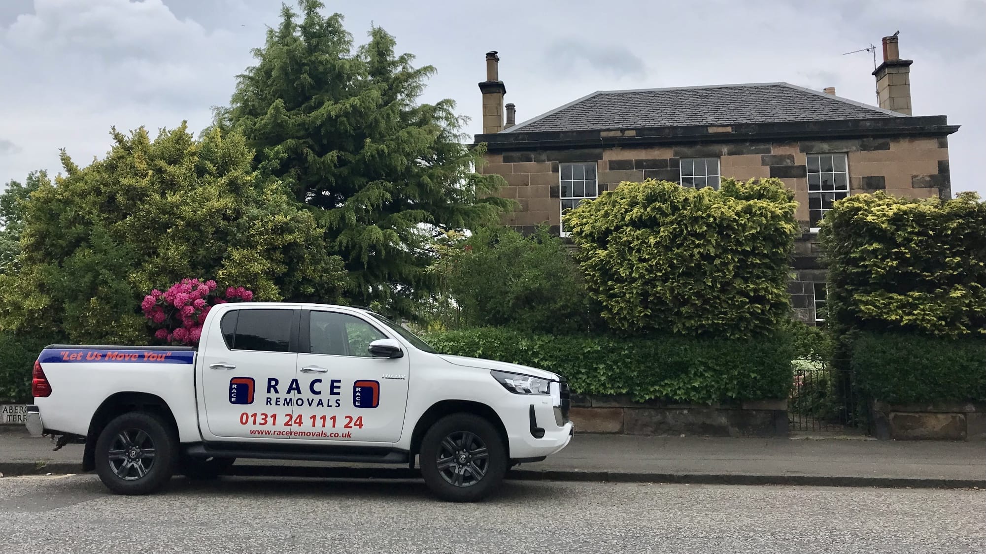 race removals pickup outside a house parked on street
